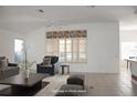 Staged living room with vaulted ceilings, tile floors, and bright window at 6688 Sw 113Th Pl, Ocala, FL 34476