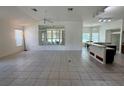 Spacious living room with tile flooring flowing into an open kitchen and dining area at 6688 Sw 113Th Pl, Ocala, FL 34476