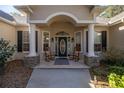 Front porch with columns, rocking chairs, and a welcoming entryway at 5425 Se 44Th Cir, Ocala, FL 34480