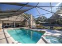 Screened pool and spa with a spacious backyard at 5425 Se 44Th Cir, Ocala, FL 34480