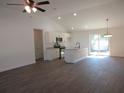Open-concept kitchen with stainless steel appliances, granite countertops, and hardwood floors at 13024 Ne 6 Pl, Silver Springs, FL 34488