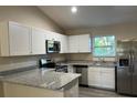 Modern kitchen featuring stainless steel appliances and granite countertops at 4131 Se 130Th Pl, Belleview, FL 34420