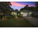 Charming single-story home with well-manicured lawn and two-car garage under a colorful sunset sky at 7947 Sw 83Rd Pl, Ocala, FL 34476