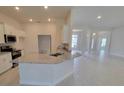 Spacious kitchen with granite countertops and stainless steel appliances overlooks the breakfast nook and living spaces at 8309 Sw 58Th Ave, Ocala, FL 34476