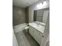 Clean bathroom featuring a bathtub and gray tile at 15923 Sw 41St Street Rd, Ocala, FL 34481