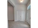 Bright foyer with tile floors, a large window, and double doors offering ample closet space at 7695 Sw 103Rd Loop, Ocala, FL 34476