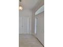 Bright entryway with neutral tones, tile floors, and natural light at 7703 Sw 103Rd Loop, Ocala, FL 34476