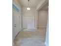 Bright entryway features tile flooring, white doors, and a transom window for natural light at 11503 Sw 65Th Avenue Rd, Ocala, FL 34476