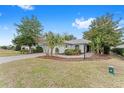 Single-story house with a red door and landscaped yard at 8718 Sw 83Rd Loop, Ocala, FL 34481