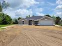 Beautiful single-story home featuring a large two car garage and freshly laid yard at 9679 Sw 46Th Ct, Ocala, FL 34476