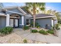 Inviting home entrance featuring a stone pathway and a double door beneath a covered entry at 8448 Se 161St St, Summerfield, FL 34491