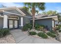 Front entrance with double doors and walkway at 8448 Se 161St St, Summerfield, FL 34491