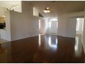 Spacious living room featuring hardwood floors, a ceiling fan, and a bright entryway with lots of light at 10819 Sw 84Th Ter, Ocala, FL 34481