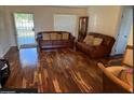 Living room with hardwood floors and brown leather couches at 35 Hemlock Terrace Dr, Ocala, FL 34472