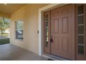 Front entry with brown door and sidelights at 3921 Sw 51St Ter, Ocala, FL 34474