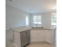 Modern kitchen island with granite countertops and stainless steel dishwasher at 6821 Se 103Rd St, Belleview, FL 34420