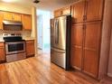 Efficient kitchen with wood cabinets and stainless steel appliances at 711 Ne 43Rd St, Ocala, FL 34479