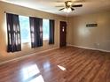 Bright living room featuring hardwood floors and large windows at 711 Ne 43Rd St, Ocala, FL 34479