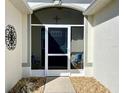 Inviting front porch features decorative metal art and chairs, perfect for relaxing outside the home's entrance at 16304 Sw 12Th Ter, Ocala, FL 34473