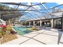 Gorgeous screened-in pool with ample patio space and outdoor lounge area at 2023 Se Laurel Run Dr, Ocala, FL 34471