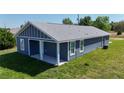 Exterior side view of single Gathering home featuring a covered patio with two support beams at 3496 Sw 149Th Ct, Ocala, FL 34481