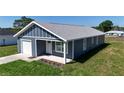 Charming single Gathering home featuring a one car garage and covered front porch at 3496 Sw 149Th Ct, Ocala, FL 34481