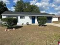 Charming one story home featuring a fresh paint job and a driveway leading to the attached garage at 41 Hickory Trak, Ocala, FL 34472