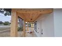 View of the home's charming front porch with wooden beams and ceiling at 519 Sw 19Th Ave, Ocala, FL 34471