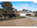 House exterior showcasing a two-car garage and neatly landscaped front yard at 7947 Sw 80Th Place Rd, Ocala, FL 34476