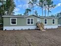 Single-wide manufactured home with light green siding and wood steps at 11645 Nw 20Th St, Ocala, FL 34482