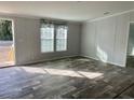 Bright living room with wood-look floors and large windows at 11645 Nw 20Th St, Ocala, FL 34482