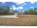 New construction home showcasing a two-car garage and expansive yard at 8436 Sw 136Th Ter, Dunnellon, FL 34432