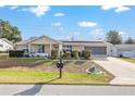 House exterior featuring a well-maintained lawn at 8968 Sw 116Th Place Rd, Ocala, FL 34481