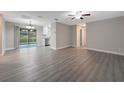 Bright living room featuring gray vinyl plank flooring and updated lighting at 7 Teak Loop Pl, Ocala, FL 34472