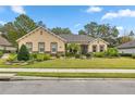 Charming single-story home with mature landscaping, lush green lawn, and brick and stone accents at 3907 Se 10Th Ave, Ocala, FL 34480