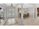 Elegant foyer featuring tiled floors, chandelier lighting, and arched doorway at 3907 Se 10Th Ave, Ocala, FL 34480
