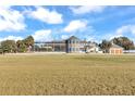 Exterior of a large, luxurious home with a pool and expansive yard at 8444 Leeward Air Ranch Cir, Ocala, FL 34472