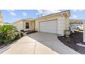 Front view of a single story house with a driveway and garage at 2840 Leicester Ter, The Villages, FL 32162