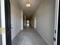 Inviting hallway with tile flooring and neutral walls, illuminated by recessed lighting throughout at 4445 Sw 90Th Pl, Ocala, FL 34476