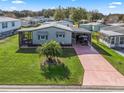 Bird's-eye view of a manufactured home with a spacious yard at 816 Hibiscus Dr, The Villages, FL 32159