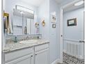 Bathroom with white cabinets, granite countertop, and updated fixtures offers a clean and modern aesthetic at 816 Hibiscus Dr, The Villages, FL 32159