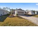 Single-story house with gray garage door and landscaped yard at 10218 Sw 99Th Ln, Ocala, FL 34481