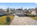 New home with two-car garage, paver driveway and landscaping at 10282 Sw 99Th Ln, Ocala, FL 34481