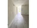 Bright hallway features new wood-look flooring and neutral paint, offering a clean, modern aesthetic at 21111 Se Honeysuckle St, Dunnellon, FL 34431