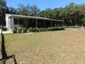 Beautiful, screened-in back porch with plenty of greenery at 11064 Ne 212Th Ln, Fort Mc Coy, FL 32134