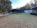 Large backyard with covered shelter, storage shed, and fenced area at 11064 Ne 212Th Ln, Fort Mc Coy, FL 32134