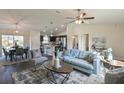 Open-concept living space with light gray sofa, dark wood coffee table, and stylish decor at 13351 Sw 83Rd Cir, Ocala, FL 34473