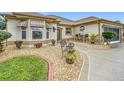 Landscaped front yard with seating area and decorative plants at 2117 Sansores St, The Villages, FL 32159