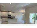 Bright kitchen featuring white cabinets, stainless steel appliances, and a granite countertop island at 2134 Nw 23Rd Loop, Ocala, FL 34475