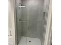 Modern glass-enclosed shower with gray tile and built-in niche in the primary bathroom at 2134 Nw 23Rd Loop, Ocala, FL 34475